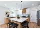 Bright, modern kitchen with a large island, seating, stainless steel appliances, and stylish pendant lighting at 1667 Grace Se St, Atlanta, GA 30316