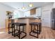 Modern kitchen featuring a large island with barstool seating and stylish lighting fixtures at 1667 Grace Se St, Atlanta, GA 30316