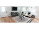 Open-concept living room with hardwood floors, modern decor and lots of natural light at 1667 Grace Se St, Atlanta, GA 30316