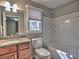 Bright bathroom featuring a vanity with granite countertop, toilet, and tub with shower at 2157 Killian Nw Way, Kennesaw, GA 30152