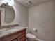 Comfortable bathroom featuring a vanity with granite countertop, a round mirror, and toilet at 2157 Killian Nw Way, Kennesaw, GA 30152