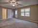 Spacious carpeted bedroom with a ceiling fan, multiple doors, and a large window at 2157 Killian Nw Way, Kennesaw, GA 30152