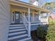 Welcoming front porch with white railings, gray painted stairs and a charming storm door at 2157 Killian Nw Way, Kennesaw, GA 30152
