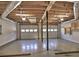 Spacious three car garage featuring high ceilings and shelving at 2157 Killian Nw Way, Kennesaw, GA 30152