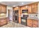 Spacious kitchen featuring stainless steel refrigerator, custom wood cabinetry and tile floors at 2157 Killian Nw Way, Kennesaw, GA 30152