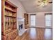 Bright living room with hardwood floors, built-in bookshelves, a fireplace, and a ceiling fan at 2157 Killian Nw Way, Kennesaw, GA 30152