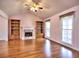 Bright living room with hardwood floors, built-in bookshelves, a fireplace, and large windows at 2157 Killian Nw Way, Kennesaw, GA 30152