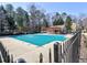 Community pool with cover, surrounded by a black fence and mature trees at 2157 Killian Nw Way, Kennesaw, GA 30152