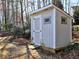 Charming storage shed with a window and painted trim, nestled in a wooded area at 2157 Killian Nw Way, Kennesaw, GA 30152