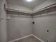 A minimalist walk-in closet features white shelving and hanging space for efficient storage at 2157 Killian Nw Way, Kennesaw, GA 30152