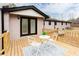 Back deck with a small table and two chairs with an exterior view of the house at 2177 American Legion Rd, Dacula, GA 30019