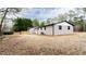 Wide shot of the home's backyard and back of the house, including the deck and propane tank at 2177 American Legion Rd, Dacula, GA 30019