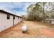 Large backyard with a propane tank, trees and shrubs surrounding the back of the house at 2177 American Legion Rd, Dacula, GA 30019