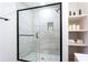 Bright bathroom featuring a glass shower, wood shelves, and modern fixtures at 2177 American Legion Rd, Dacula, GA 30019