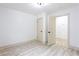 Minimal bedroom showcasing fresh paint, neutral trim and modern lighting, with closet and interior door at 2177 American Legion Rd, Dacula, GA 30019