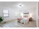 Bedroom featuring modern lighting, wood-look flooring, and natural lighting at 2177 American Legion Rd, Dacula, GA 30019