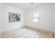 Bright bedroom with light wood floors, a minimalist aesthetic, and a view to the outside at 2177 American Legion Rd, Dacula, GA 30019