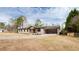 View of the exterior of the home, featuring painted brick, a covered front porch, and an attached carport at 2177 American Legion Rd, Dacula, GA 30019