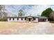 Charming renovated ranch-style home with a painted brick exterior and covered carport on a sunny day at 2177 American Legion Rd, Dacula, GA 30019