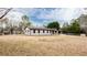 Single-story home features a painted brick exterior, black trim, and attached carport in a spacious yard at 2177 American Legion Rd, Dacula, GA 30019