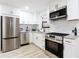 Bright kitchen with white cabinets, stainless steel appliances, and granite countertops at 2177 American Legion Rd, Dacula, GA 30019