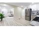 A kitchen view from the living room, featuring stainless steel appliances and white cabinets at 2177 American Legion Rd, Dacula, GA 30019