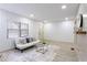 Bright living room boasts natural light, hardwood floors, neutral colors, and minimalist decor at 2177 American Legion Rd, Dacula, GA 30019