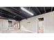 Unfinished basement space with painted ceiling, concrete floor, staircase and doorway at 3263 Dodson Dr, Atlanta, GA 30344
