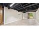 Unfinished basement with painted ceiling, concrete floor and door to the backyard at 3263 Dodson Dr, Atlanta, GA 30344