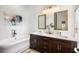 A luxurious bathroom featuring double sinks, a standalone tub, stylish fixtures, and elegant decor at 11279 Serenbe Ln, Chattahoochee Hills, GA 30268