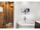 Bright bathroom features a modern tub, a glass-enclosed shower with wood-look tiling, and upscale finishes at 11279 Serenbe Ln, Chattahoochee Hills, GA 30268