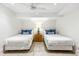 Clean bedroom with two twin beds and a shared nightstand featuring a stylish lamp at 11279 Serenbe Ln, Chattahoochee Hills, GA 30268