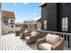Outdoor deck with comfortable seating and views of surrounding houses and blue sky at 11279 Serenbe Ln, Chattahoochee Hills, GA 30268