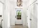 Welcoming entryway with stone floors and a view to the outside via a glass paned door at 11279 Serenbe Ln, Chattahoochee Hills, GA 30268