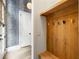 Entryway with bench, mounted coat hooks, and printed wallpaper at 11279 Serenbe Ln, Chattahoochee Hills, GA 30268