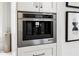 Stainless steel built-in coffee maker in white cabinetry at 11279 Serenbe Ln, Chattahoochee Hills, GA 30268
