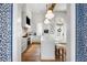 Island kitchen boasts a stainless steel refrigerator and mounted television at 11279 Serenbe Ln, Chattahoochee Hills, GA 30268