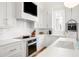 Bright kitchen features white cabinets, stainless steel appliances, and sleek countertops at 11279 Serenbe Ln, Chattahoochee Hills, GA 30268