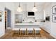 Well-lit kitchen with white cabinets, stainless steel appliances, and a center island with seating at 11279 Serenbe Ln, Chattahoochee Hills, GA 30268