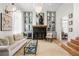 Bright living room featuring a fireplace, built-in cabinets, hardwood floors, and stylish decor at 11279 Serenbe Ln, Chattahoochee Hills, GA 30268