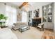 Cozy living room features built-in cabinets, a fireplace and lots of natural light from the windows at 11279 Serenbe Ln, Chattahoochee Hills, GA 30268