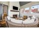Enclosed sunroom with a brick fireplace, comfortable sofa and lots of natural light at 11279 Serenbe Ln, Chattahoochee Hills, GA 30268