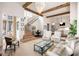 Open-concept living space with high ceilings, wood beams, staircase and eat-in kitchen at 11279 Serenbe Ln, Chattahoochee Hills, GA 30268