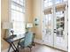 Bright home office with herringbone floors, natural light, and french doors at 11279 Serenbe Ln, Chattahoochee Hills, GA 30268