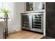 A wine refrigerator is conveniently located in the built-in cabinet in the living room at 11279 Serenbe Ln, Chattahoochee Hills, GA 30268