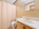 Bathroom featuring yellow wallpaper, mirror, single sink and toilet at 1184 Alemeda Dr, Marietta, GA 30066
