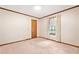 Bedroom featuring neutral carpet, wood trim, and a window view at 1184 Alemeda Dr, Marietta, GA 30066