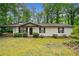 Charming single-story home with a well-maintained lawn and mature trees at 1184 Alemeda Dr, Marietta, GA 30066