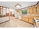 Traditional kitchen with wood cabinets, tile floors, window and view to eating and living areas at 1184 Alemeda Dr, Marietta, GA 30066