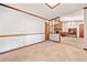 View of the living room featuring wood trim, paneled wall, and connection to dining room at 1184 Alemeda Dr, Marietta, GA 30066